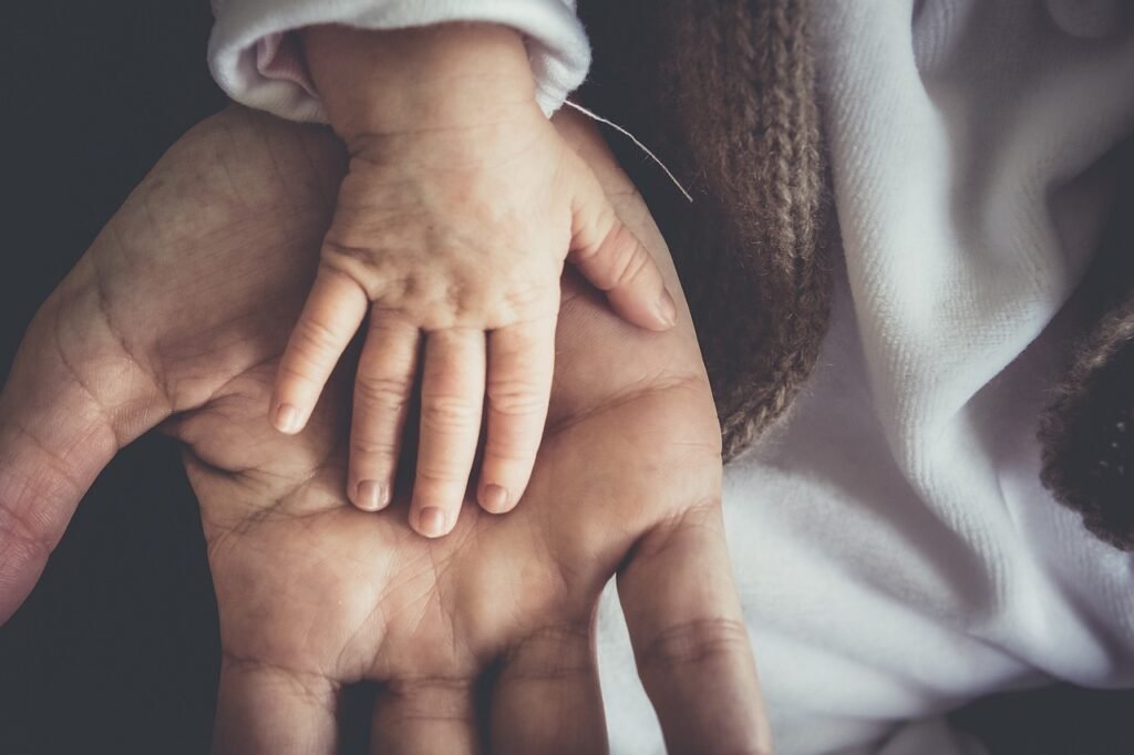 child's hand in parent's