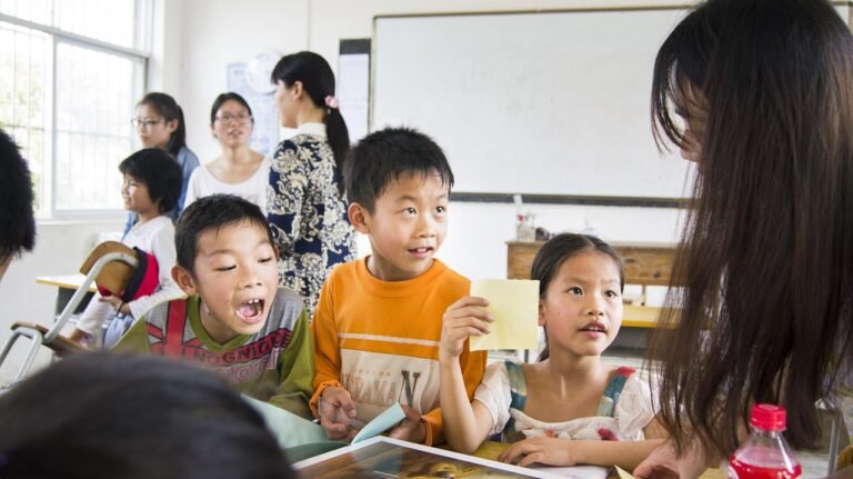 children interacting with their teacher in a classroom