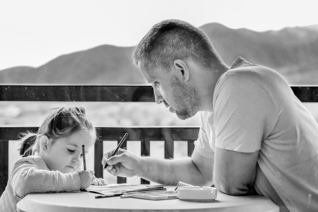image of child following her father's instructions to write