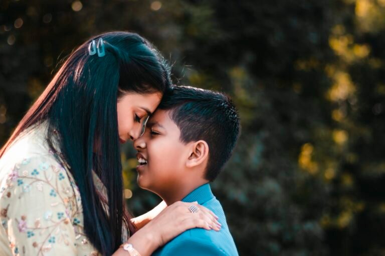 image of mother leaning her head on her son's head with closed eyes