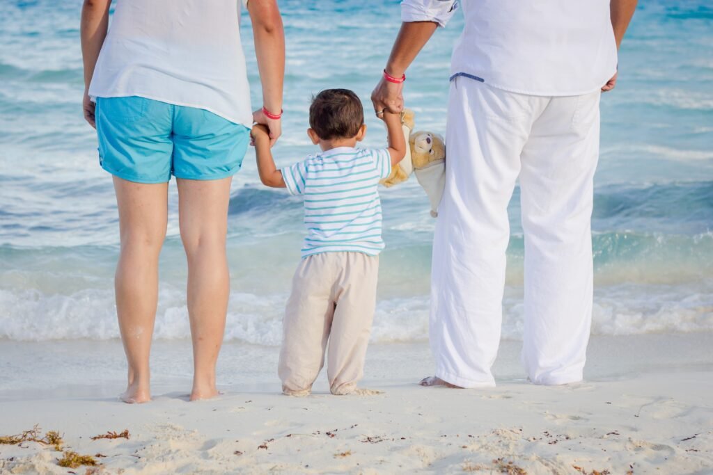 image of family walking along the beach