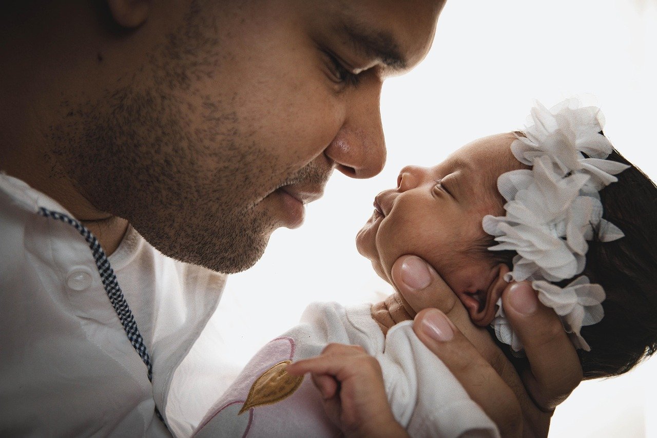 image of father looking endearingly at his daughter